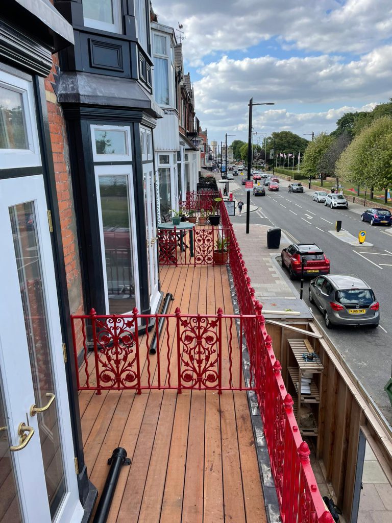 Rub red balcony in front of the properties including the decking